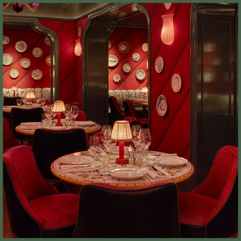 Dear Jackie restaurant at Broadwick Soho with red silk walls, Murano lighting and set dining tables.